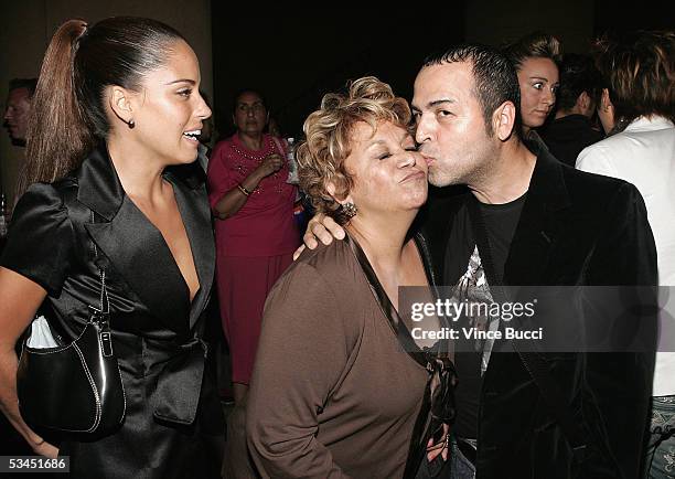 Actress Ana Claudia Talancon watches as actress Lupe Ontiveros gets a kiss from designer Luis Verdad at the afterparty for the West Coast premiere of...