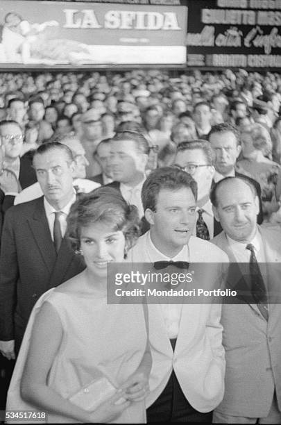 Italian actress Antonella Lualdi and her husband and Italian actor Franco Interlenghi surrounded by the crowd during the 19th Venice International...