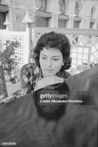 Israeli actress Haya Harareet leaning against a piece of furniture during the 19th Venice International Film Festival. Venice, August 1958