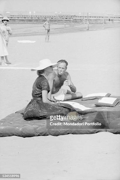 American actor Henry Fonda and his wife, Italian baroness Afdera Franchetti, on the beach during the XVIII Venice International Film Festival....