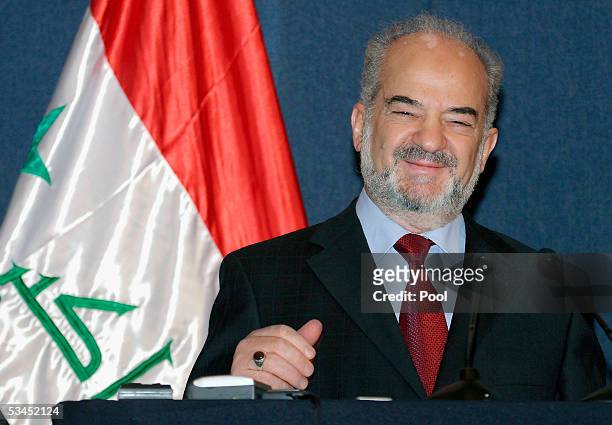 Standing next to the national flag Iraqi Prime Minister Ibrahim Jaafari laughs during a press conference in the fortified "Green Zone" August 23 in...