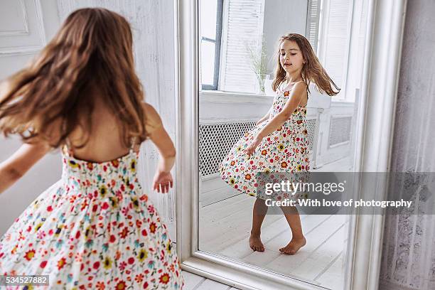 lovely little girl about 6-10 years in summer dress at the mirror - 8 9 years photos et images de collection