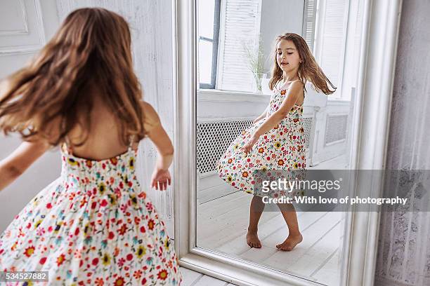 lovely little girl about 6-10 years in summer dress at the mirror - vestito da donna foto e immagini stock