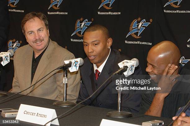 General Manager Ernie Grundfeld, Caron Butler and Chucky Atkins of the Washington Wizards during a press conference announcing the siginings of...