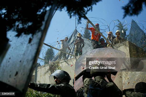 Right-wing Jewish settlers attack Israeli police trying to break through barricades onto the synagogue roof to remove the militants during the...