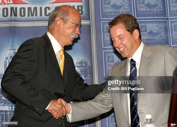 Outgoing Chrysler Group CEO Dieter Zetsche congratulates Ford Motor Company CEO Bill Ford on taking over the reigns as Chairman of the Detroit...