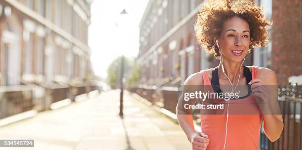 city jog - woman home run stock pictures, royalty-free photos & images