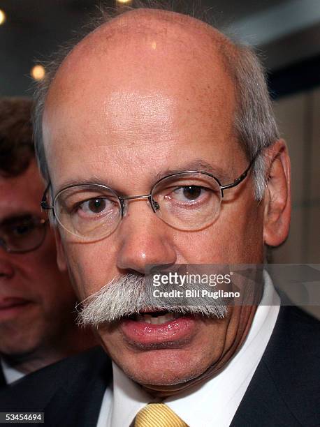 Outgoing Chrysler Group CEO Dieter Zetsche talks with reporters at a Detroit Economic Club reception for Zetsche August 23, 2005 in Detroit,...