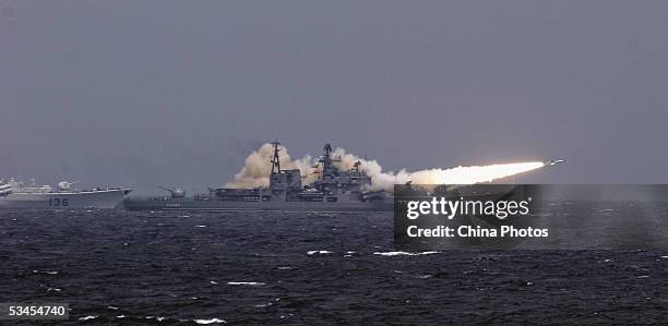 Russian destroyer launches a ship-to-ship missile in an offshore blockade exercise during the third phase of the Sino-Russian "Peace Mission 2005"...