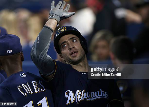Left fielder Ryan Braun of the Milwaukee Brewers is congratulated in the dugout after hitting a solo home run in the fifth inning during the game...