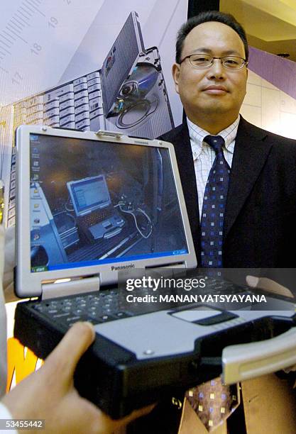 Director for India, Panasonic Systems Asia-Pacific, Chishima Susumu, poses with the newly launched Panasonic "Toughbook" laptop in New Delhi 24...