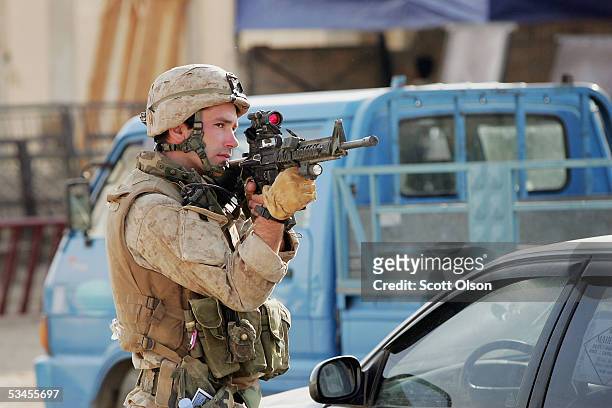 Marine Capt. David McElliott, from Seattle, Washington, with the India Company 3rd Battalion 25th Marine Regiment, guards a road during a patrol in...