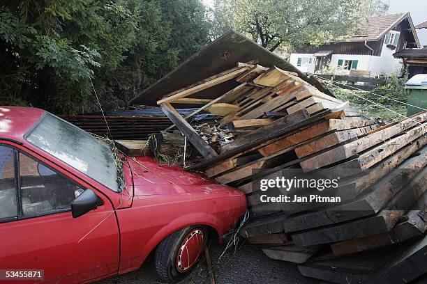 Car is damaged after a pile of wood collapsed on it due to floodwaters on August 24, 2005 in Eschenlohe, Germany. People in southern Bavaria are...