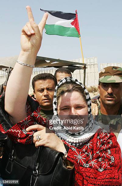 Fadwa Barghouti, wife of jailed Palestinian uprising leader Marwan Barghouti, flashes the V-sign upon her arrival at the El-Tufah checkpoint near the...