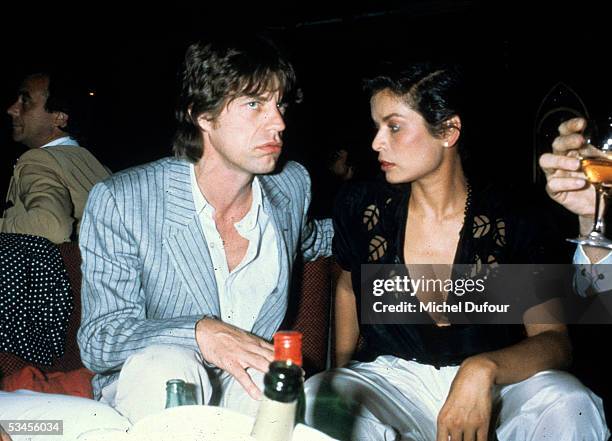 Musician Mick Jagger of The Rolling Stones and Bianca Jagger attend a party at the night club le78 in 1982 in Paris, France.