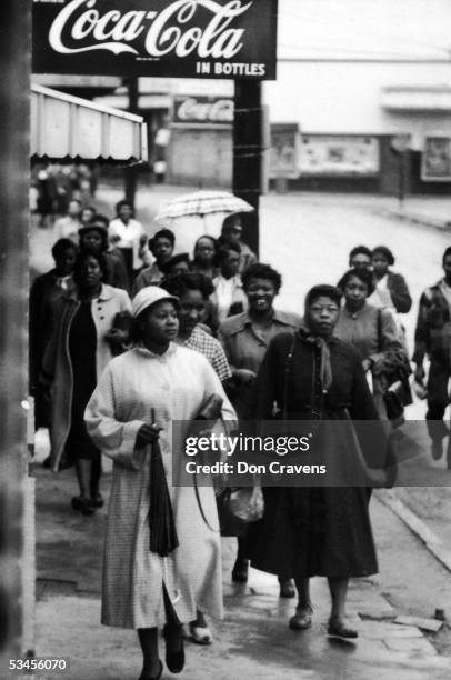 African American women walk along the sidewalk during a bus boycott, Montgomery, Alabama, February 1956.