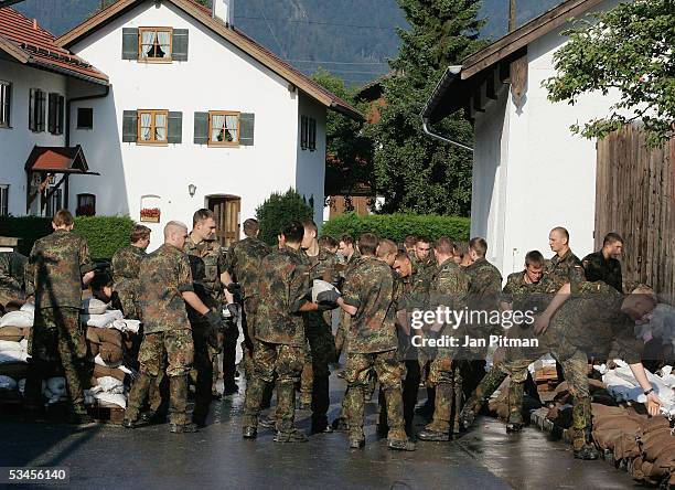 German soldiers remove sandbags on August 24, 2005 in Eschenlohe, Germany. Flooding has caused thousands of people to abandon their homes in recent...