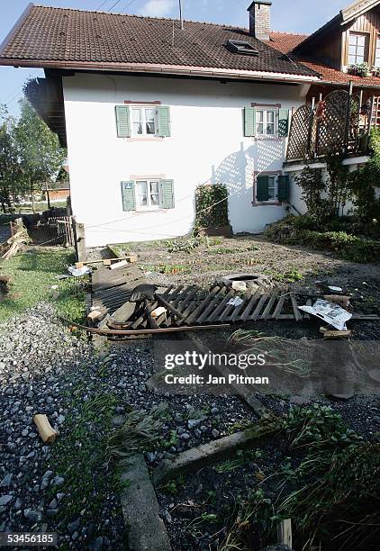 Debris lays in a garden of a house on August 24, 2005 in Eschenlohe, Germany. Flooding has caused thousands of people to abandon their homes in...