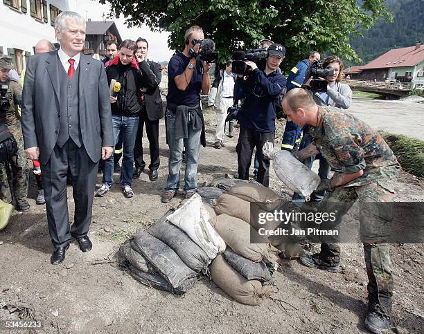 Germany's Minister for the Interior Otto Schily watches a soldier removing sandbags on August 24, 2005 in Eschenlohe, Germany. Flooding has caused...