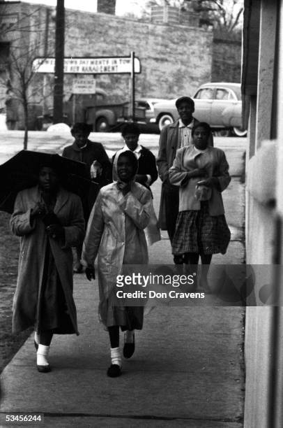 African American women walk along the sidewalk during a bus boycott, Montgomery, Alabama, February 1956.