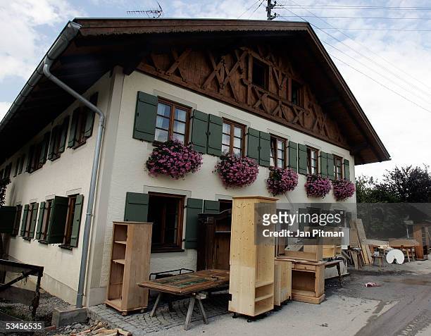 Furniture stands outside a house as cleanup continues August 24, 2005 in Eschenlohe, Germany. Residents in southern Bavaria are now cleaning up the...
