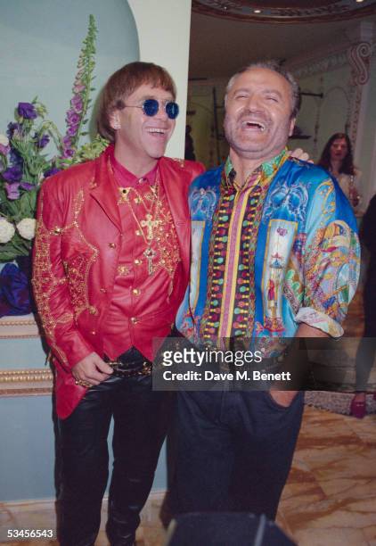 Fashion designer Gianni Versace enjoys a joke with singer Elton John at the opening of the new Versace shop, 28th May 1992.