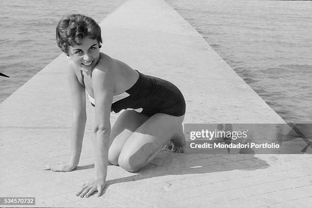 Italian actress Lucia Banti in a bikini on a jetty during the XVIII Venice International Film Festival. Venice, 1957