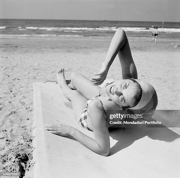 Italian actress Lucia Banti lying the beach during the XVIII Venice International Film Festival. Venice, 1957