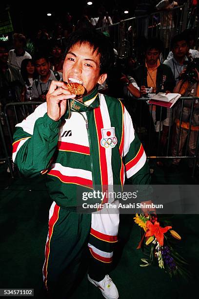 Gold medalist Tadahiro Nomura of Japan celebrate after the medal ceremony for the Judo Men's -60kg during the Atlanta Summer Olympic Games at the...