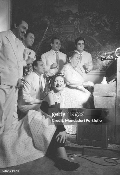 Greek soprano Maria Callas listening to American journalist Elsa Maxwell playing the piano with some musicians during the XVIII Venice International...