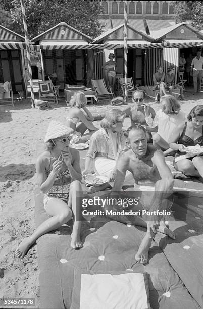 American actor Henry Fonda and his wife, Italian baroness Afdera Franchetti, relaxing on the beach during the XVIII Venice International Film...