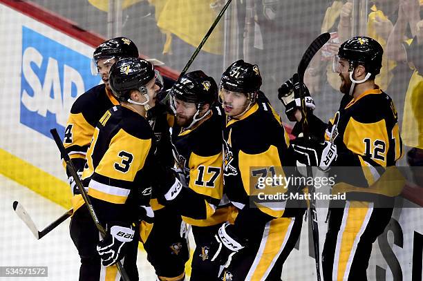 Bryan Rust of the Pittsburgh Penguins celebrates with his teammates after scoring a goal against Andrei Vasilevskiy of the Tampa Bay Lightning during...