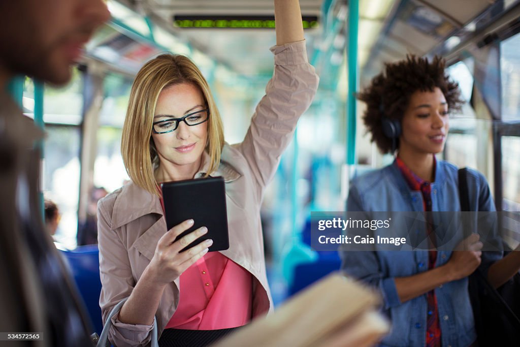 Businesswoman using digital tablet on train