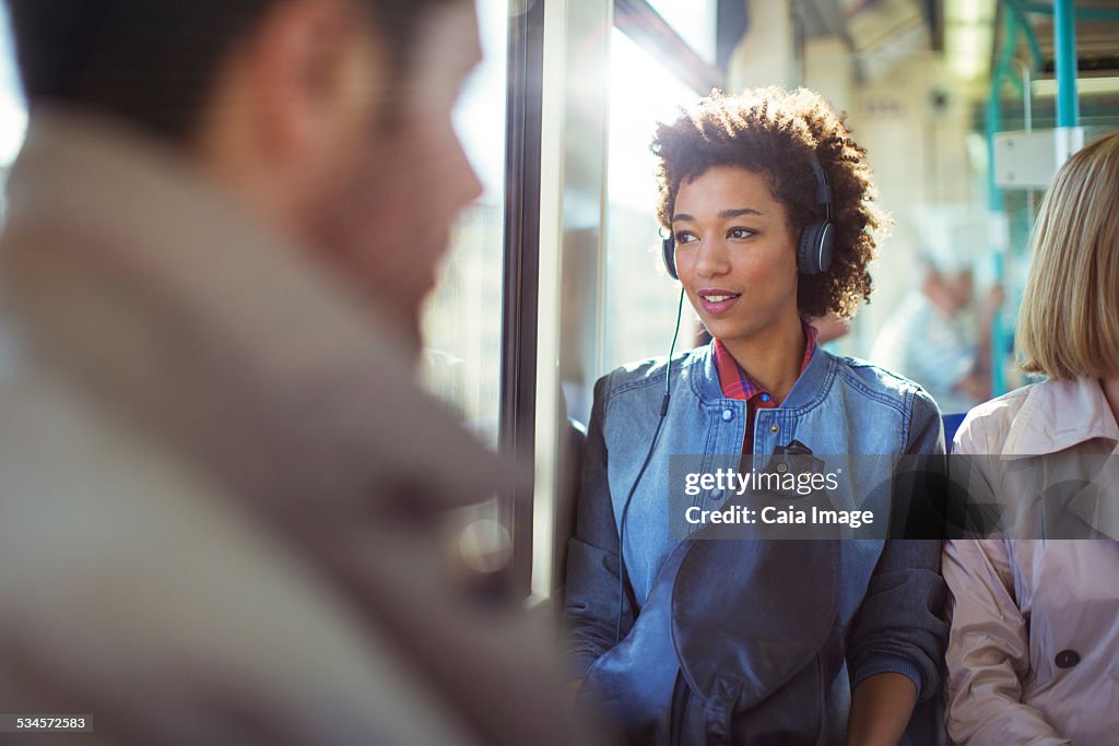 Woman listening to headphones on train