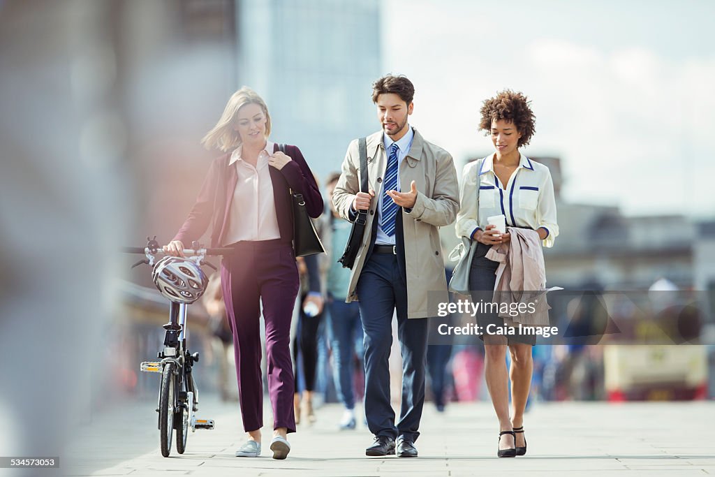 Business people walking and talking in city