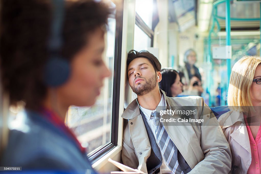 Businessman napping on train