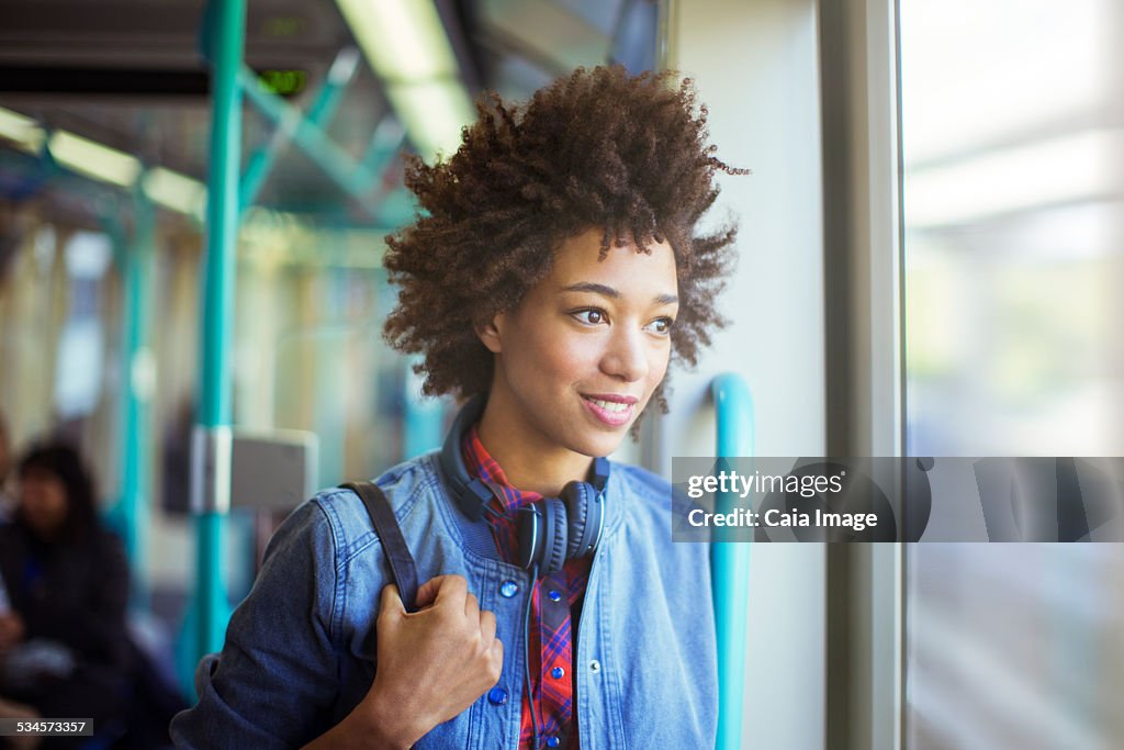 Woman looking out window of train