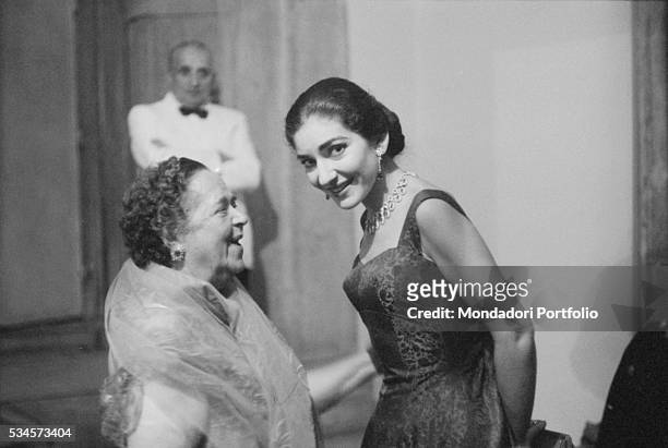 Greek soprano Maria Callas and American journalist Elsa Maxwell attending a party during the XVIII Venice International Film Festival. Venice, 1957