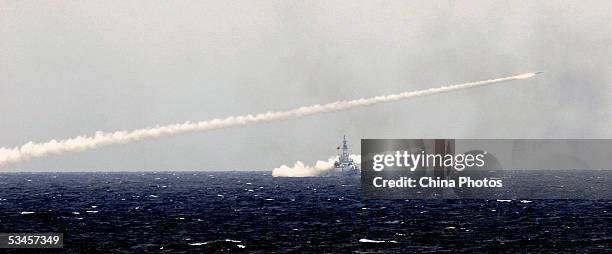 Chinese destroyer launches missiles in an offshore blockade exercise during the third phase of the Sino-Russian "Peace Mission 2005" joint military...