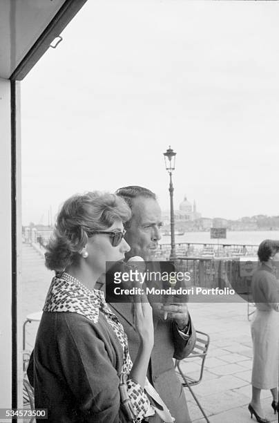 American actor Henry Fonda and his wife, Italian baroness Afdera Franchetti, eating ice cream during the XVIII Venice International Film Festival....