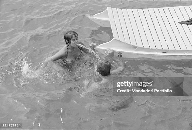 Italian actor Franco Interlenghi and his wife, Italian actress Antonella Lualdi , joking in the sea during the XVIII Venice International Film...