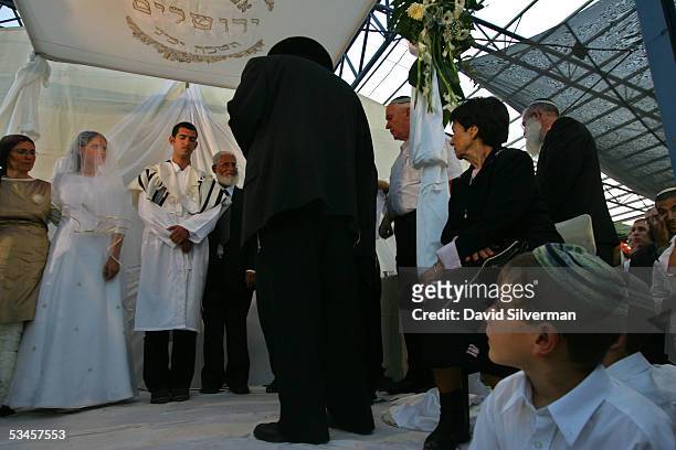 Jewish settler bride Rivka Netanel and her groom Bezalel Weinstein hold their traditional religious wedding ceremony in the Faith City settler...