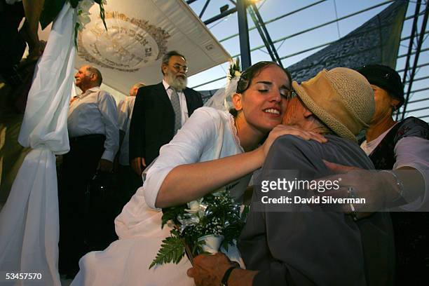 Jewish settler bride Rivka Weinstein kisses an elderly relative after her traditional religious wedding ceremony in the Faith City settler encampment...