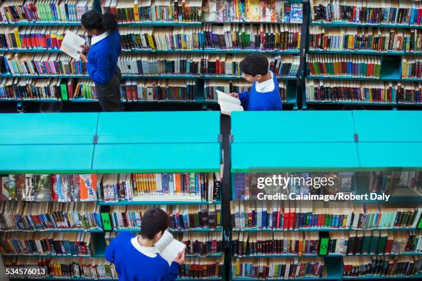 Elevated view of high school students browsing books in library