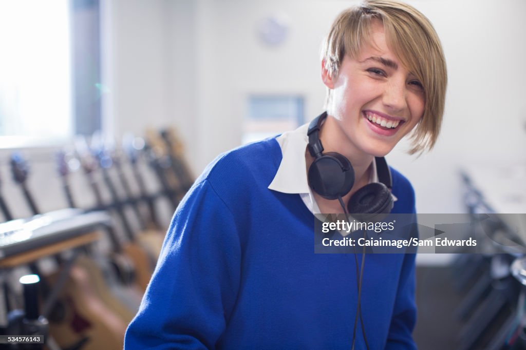 Portrait of female student with headphones in classroom