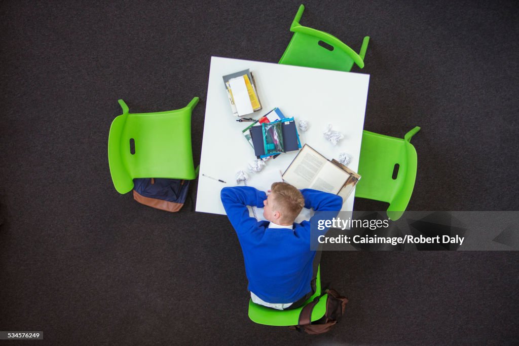 Overhead view of student sleeping on desk