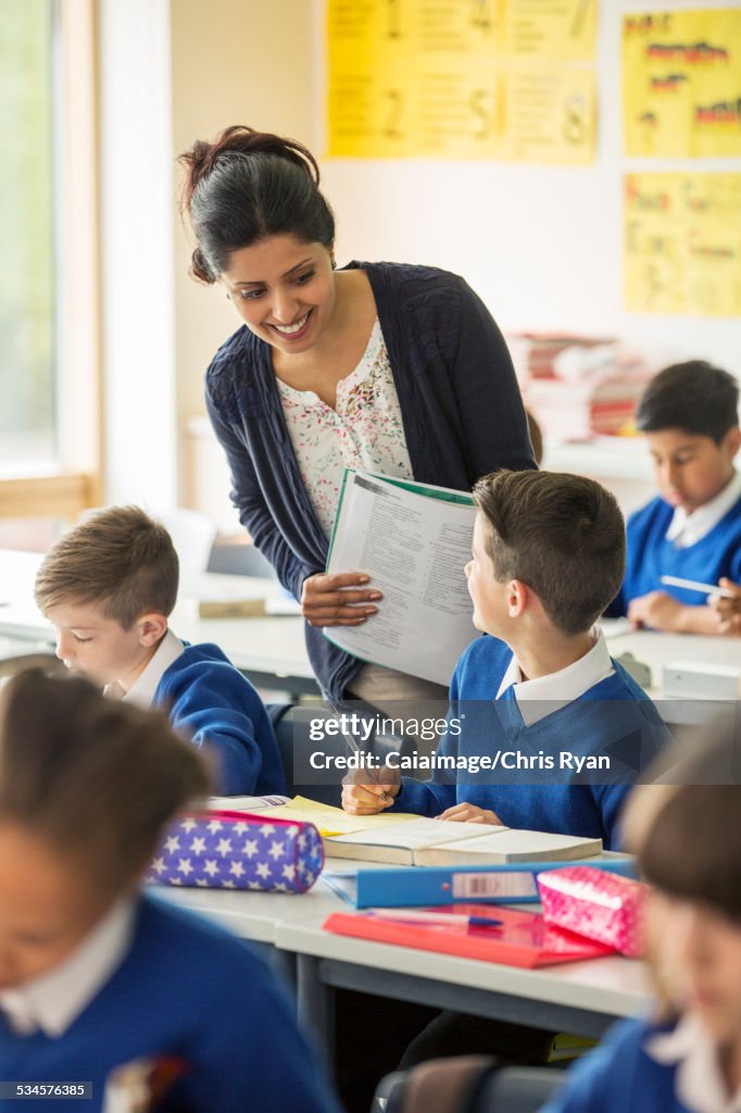 Teacher and elementary school children in classroom during lesson