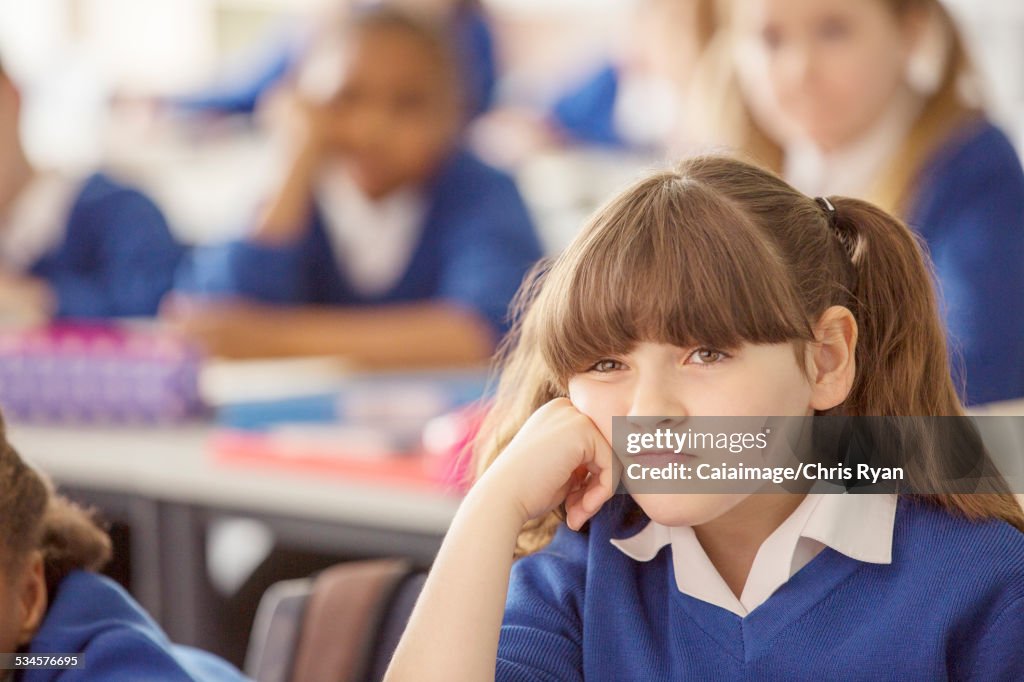 Elementary schoolgirl looking bored during lesson