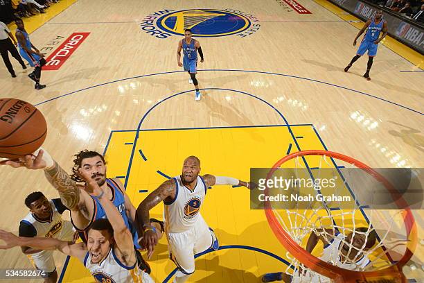 Steven Adams of the Oklahoma City Thunder jumps for the rebound against Stephen Curry of the Golden State Warriors during Game Five of the Western...