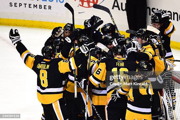 The Pittsburgh Penguins celebrate after defeating the Tampa Bay Lightning in Game Seven of the Eastern Conference Final with a score of 2 to 1 during...